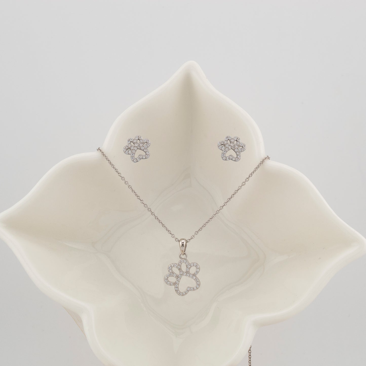 Conjunto Pendientes y Collar con Colgante Huellas Caninas. Cadena ajustable de 40cm a 43cm con cierre reasa. Pendientes en Plata de Ley 925 acabado Rodio y Zirconitas. CP4316205R - Henor